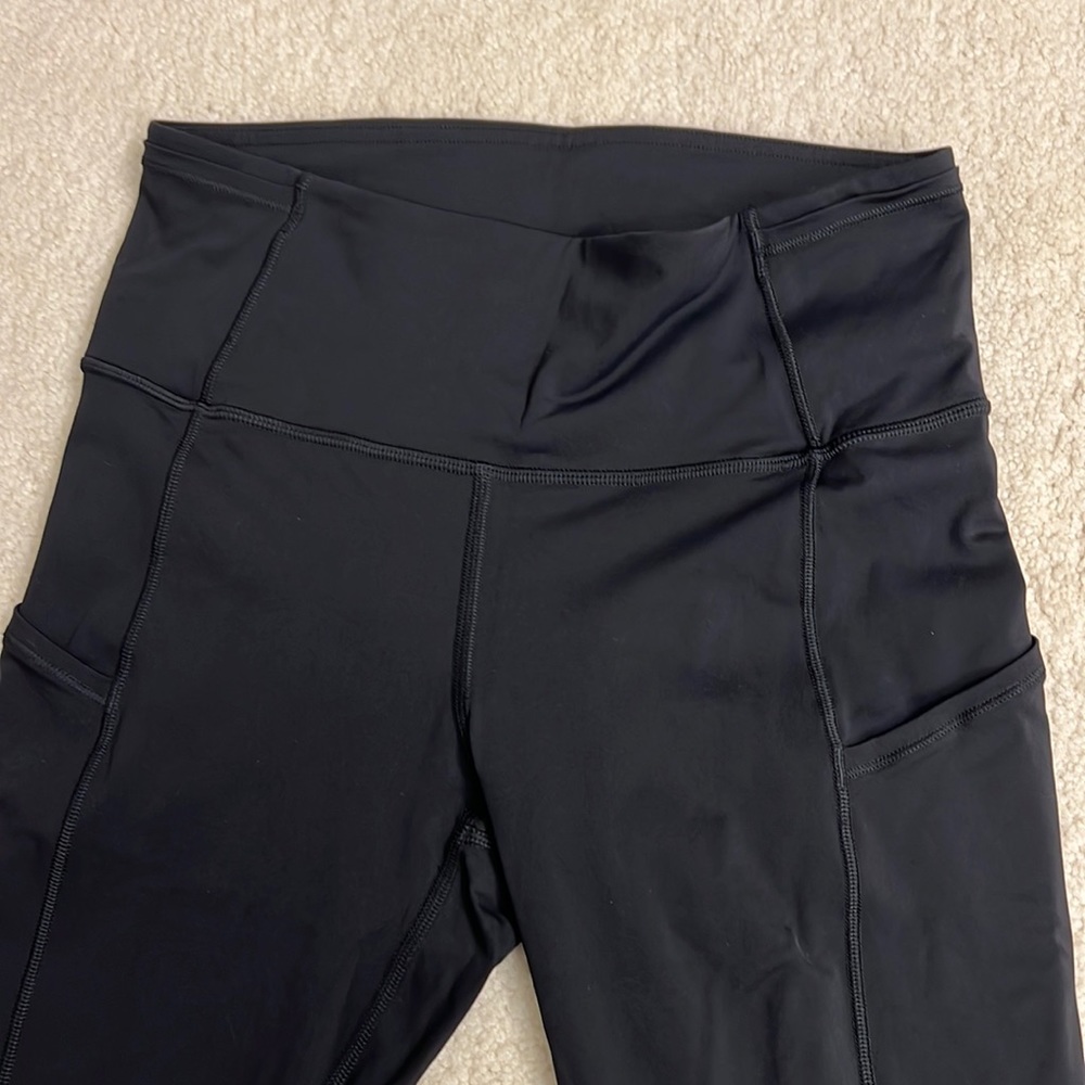 Black size 4 high rise black Lululemon leggings with side pockets.